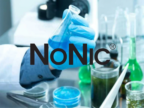 Scientist holding a beaker with synthetic NoNic® compound in lab environment, representing nicotine-free vaping innovation with blue liquid and chemical analysis tools.