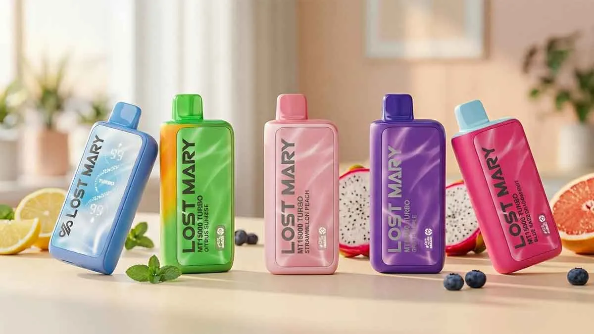 Lineup of five Lost Mary MT15000 Turbo disposable vapes in blue, green, pink, purple, and hot pink colors arranged on a sunlit table with fresh fruit including lemon, dragonfruit, grapefruit, blueberries, and mint leaves